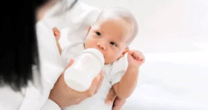 Baby enjoying their first bite of solid food
